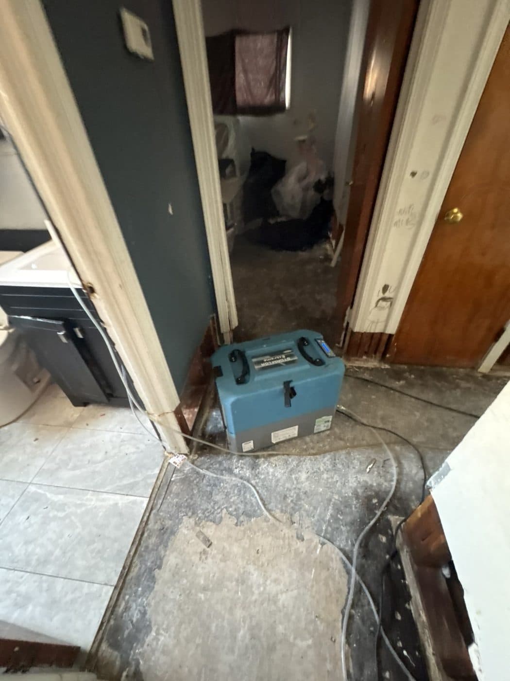 Dehumidifier running in a hallway during drying