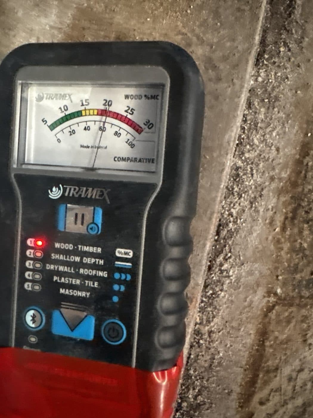 Moisture meter reading a wet floor